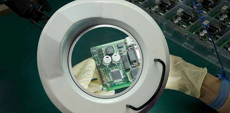 Technician inspecting circuit board